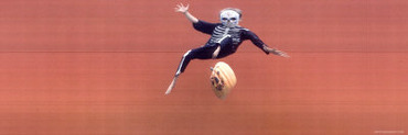 Child in Halloween Skeleton Costume Jumping in Air