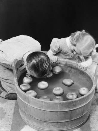 Little Boy and Girl Bobbing For Apples Fall Halloween Party Indoor