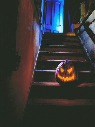 Halloween Pumpkin Sitting on Staircase